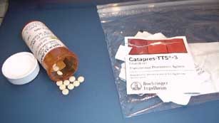 Clonidine tablets with prescription bottle and Catapres-TTS patch packs